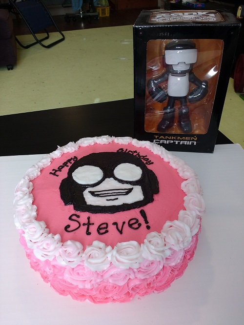 pretty pink birthday cake with Steve's face on it